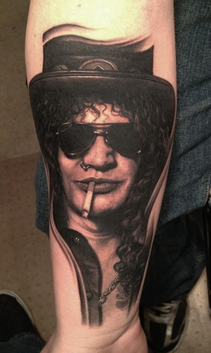 Portrait style very detailed arm tattoo of Slash face