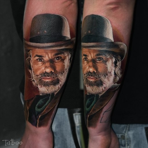 Portrait style very detailed arm tattoo of man with beard and hat