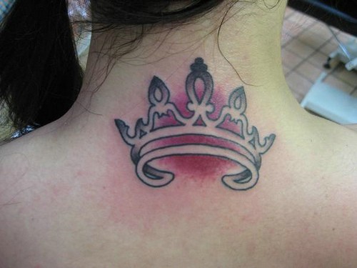 Pretty crown tattoo on upper back