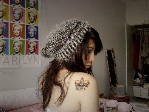 Pretty girl with crown tattoo on shoulder