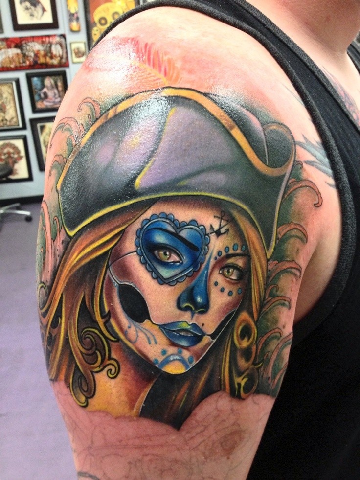 Pretty girl pirate face tattoo on boys shoulder