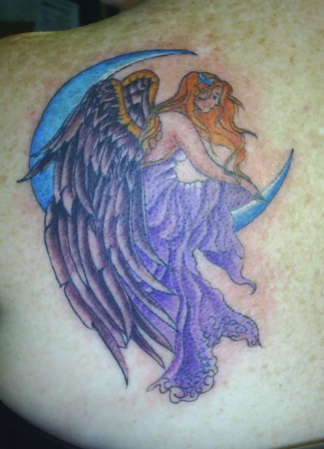 Purple angel sitting on moon tattoo on shoulder blade