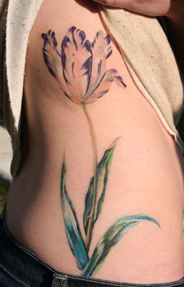 Purple tulip flower tattoo on ribs