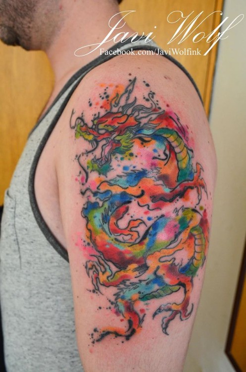 Rainbow colored Asian dragon tattoo on shoulder by Javi Wolf in watercolor style