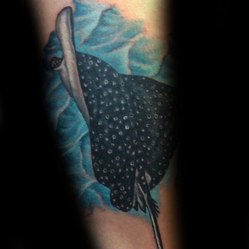 Real life like colored swimming ray tattoo on forearm