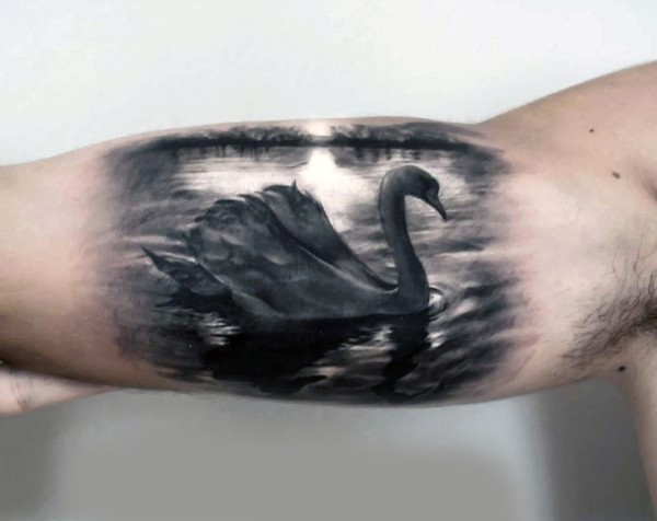 Real lifelike black ink realism style biceps tattoo of swan in lake