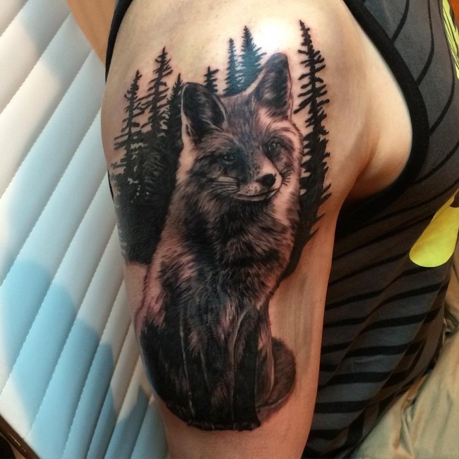 Real photo like black and white fox tattoo on shoulder with dark forest