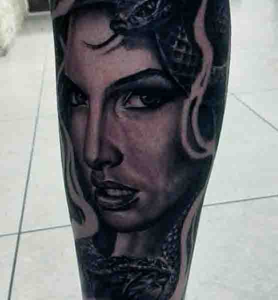Real photo like black and white seductive Medusa tattoo on leg