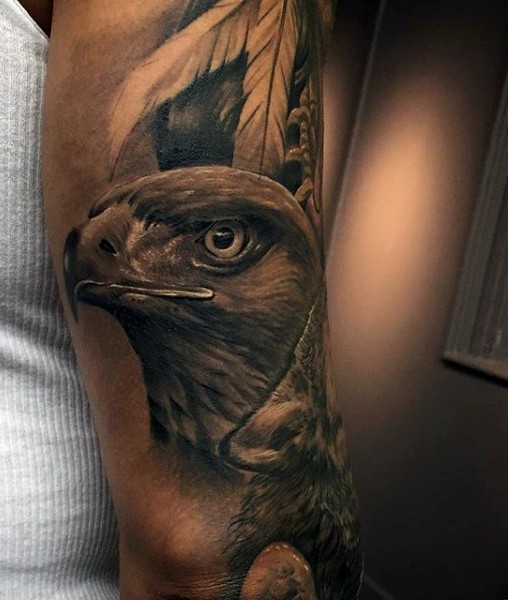 Real photo like black ink eagle tattoo on arm