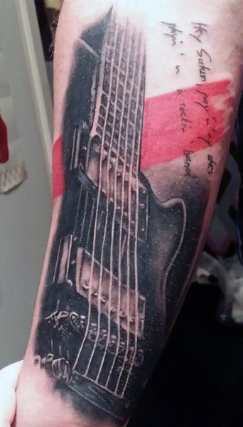 Real photo like colored guitar with lettering tattoo on arm