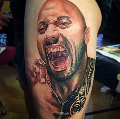 Real photo like colored on thigh tattoo of Dwayne Johnson