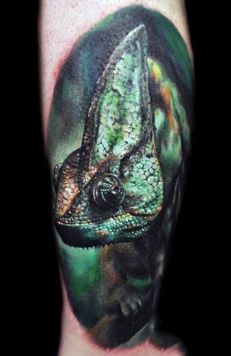 Real photo like very detailed colorful chameleon tattoo on leg