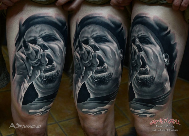 Real photo style black and white thigh tattoo of music singer