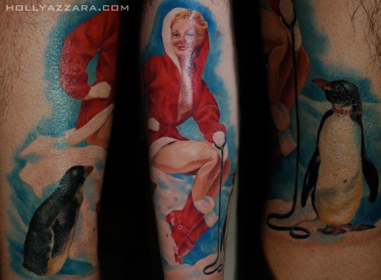 Real picture like colored sexy woman in Santa costume tattoo with penguin on arm