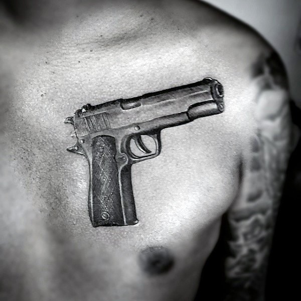 Realism style black and white 3D chest tattoo of Colt 1911 pistol