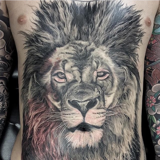 Realism style black and white chest tattoo of lion head