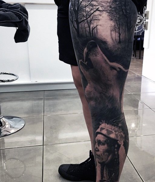 Realism style black and white leg tattoo of wolf in dark forest and Indian
