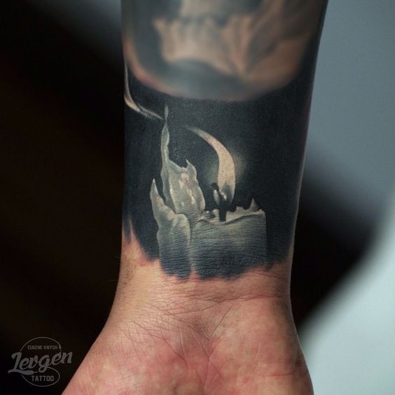 Realism style black and white wrist tattoo on candle