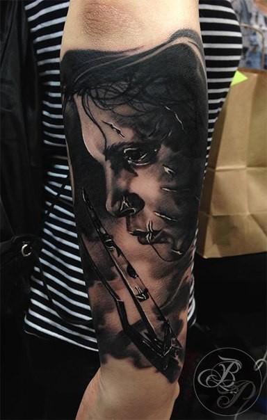 Realism style black ink arm tattoo of Edward Scissors-hands