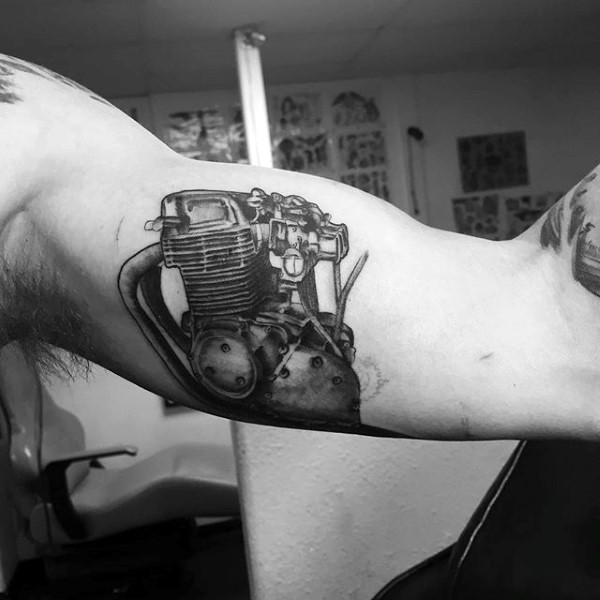 Realism style black ink detailed bike engine tattoo on biceps