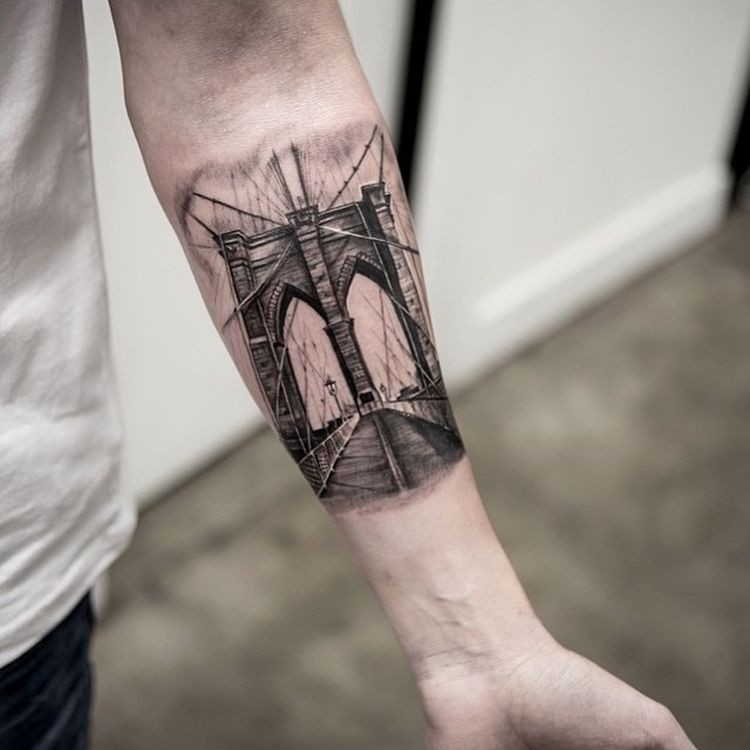 Realism style black ink forearm tattoo of old bridge