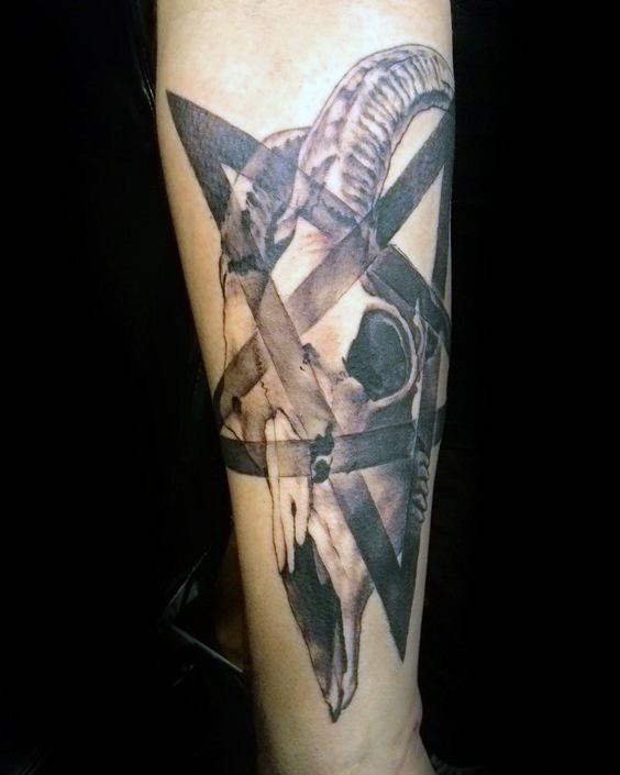 Realism style black ink forearm tattoo of goat skull with star