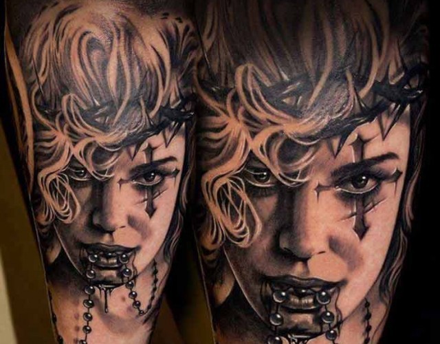 Realism style black ink thigh tattoo of creepy woman with cross and jewelry