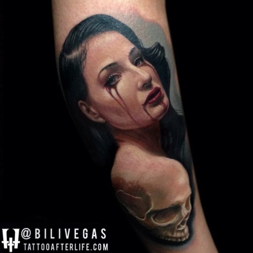 Realism style colored arm tattoo of cool looking bloody woman with skull