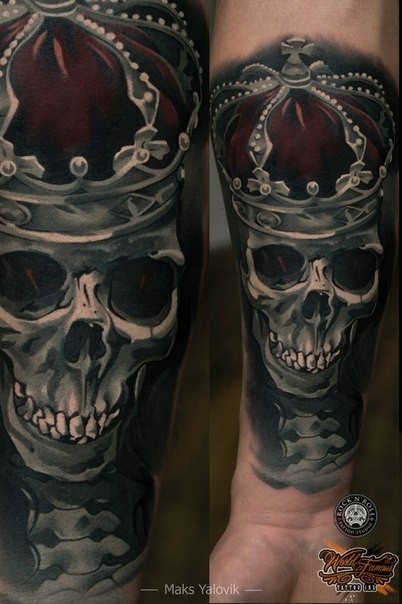 Realism style colored arm tattoo of human skull with crown