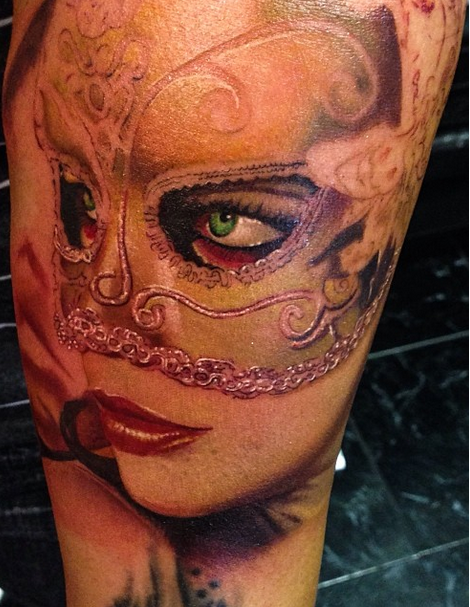 Realism style colored arm tattoo of woman with mask