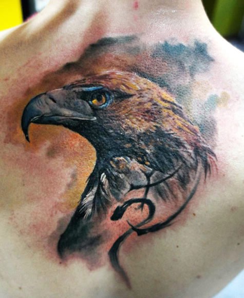 Realism style colored back tattoo of eagle with symbol