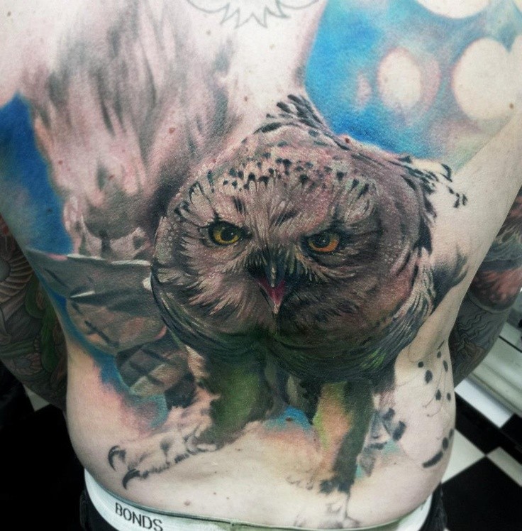 Realism style colored back tattoo of flying owl