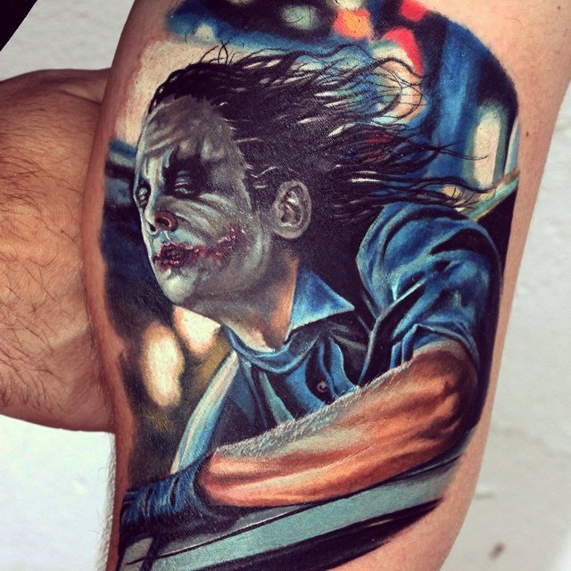 Realism style colored biceps tattoo of creepy Joker
