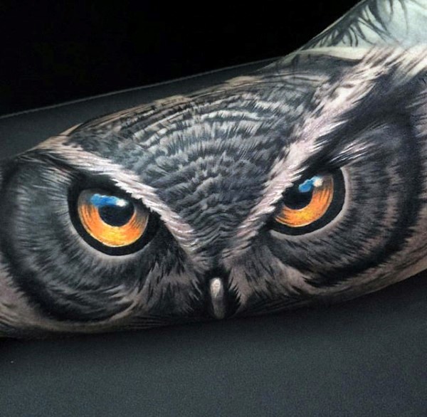 Realism style colored biceps tattoo of owl look