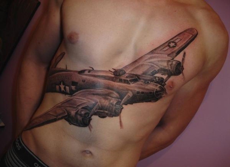 Realism style colored chest and belly tattoo of large bomber plane