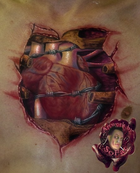 Realism style colored chest tattoo of broken bones with heart