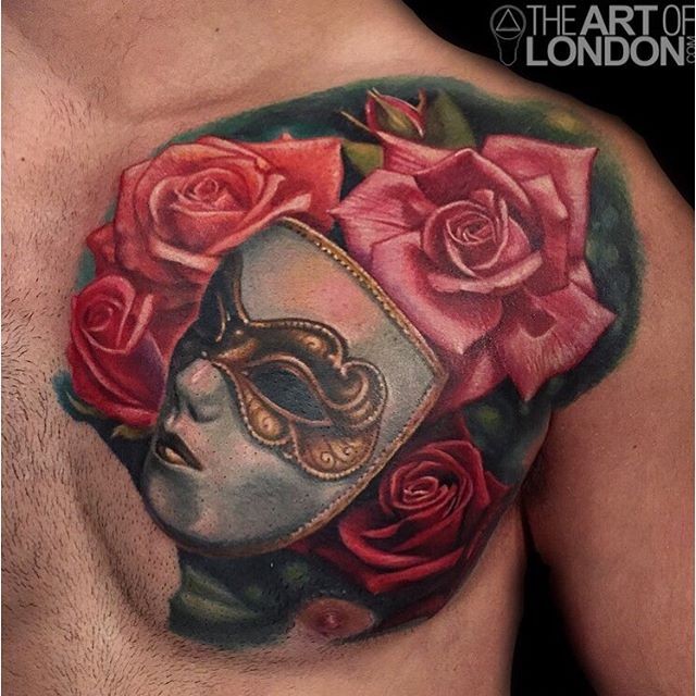 Realism style colored chest tattoo of cool mask with roses