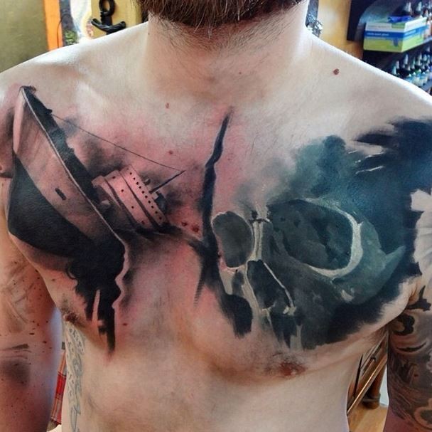 Realism style colored chest tattoo of ship and skull