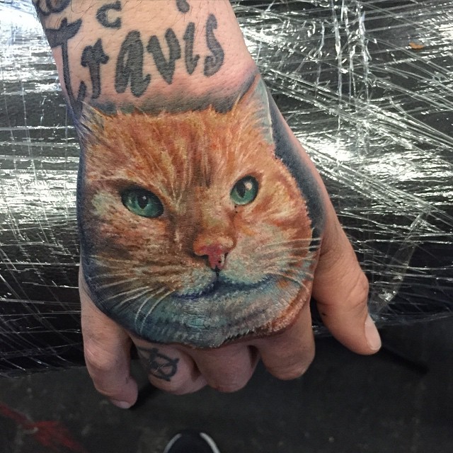 Realism style colored fist tattoo of cat head