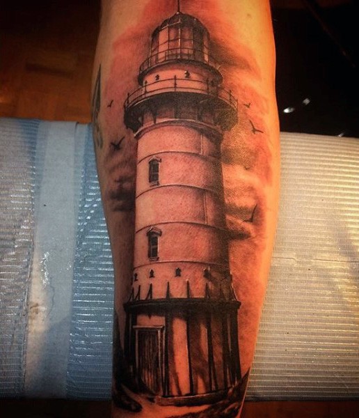 Realism style colored forearm tattoo of large lighthouse