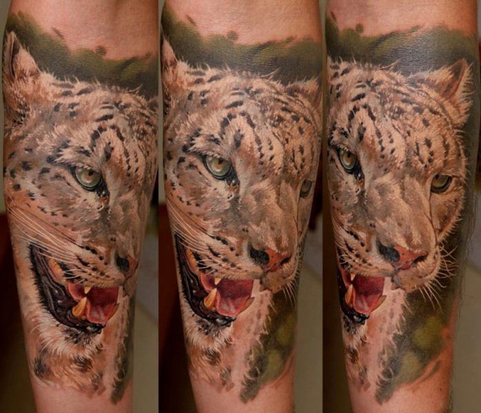Realism style colored forearm tattoo of leopard