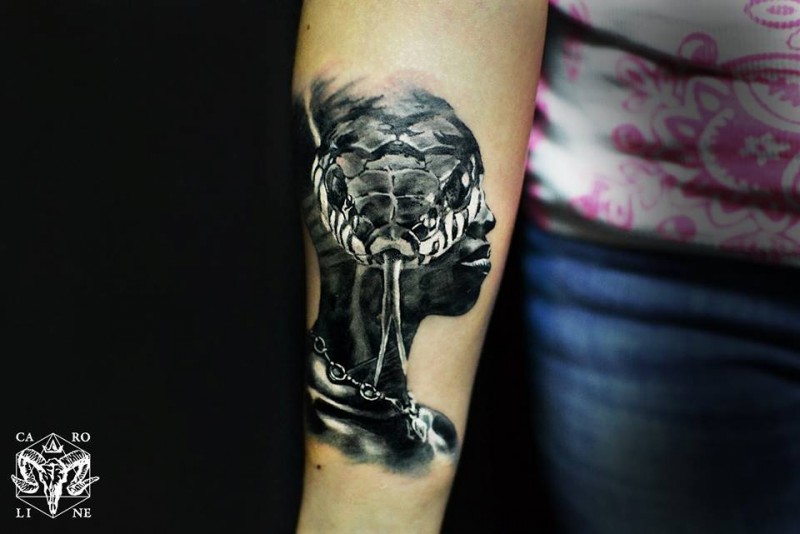 Realism style colored forearm tattoo of human face stylized with snake