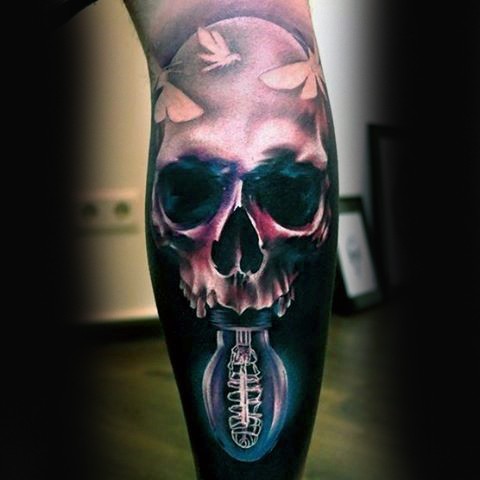 Realism style colored human skull with bulb tattoo on leg