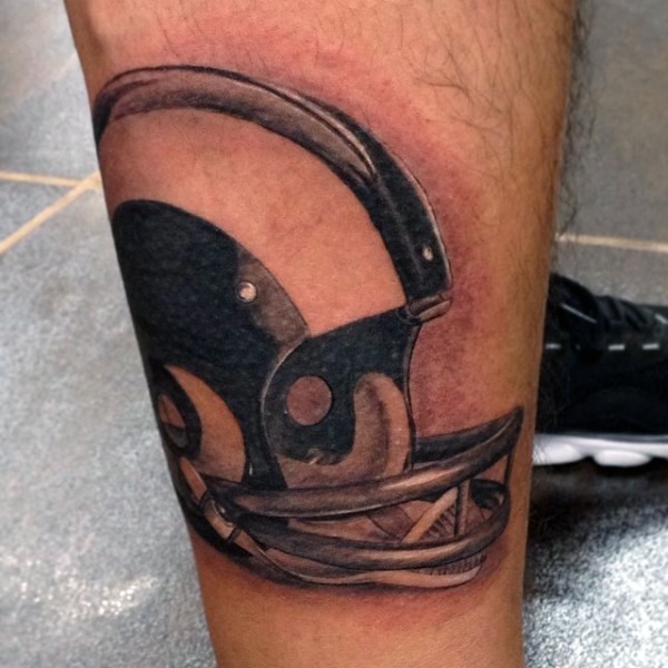 Realism style colored leg tattoo of American football helmet