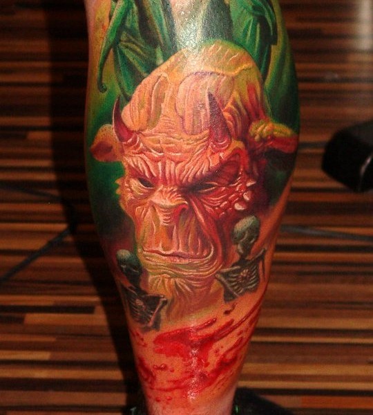 Realism style colored leg tattoo of devil face with skeleton