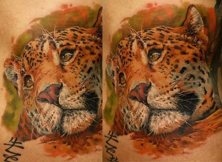 Realism style colored leopard tattoo