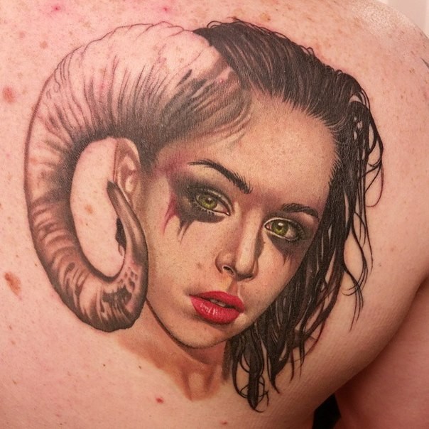 Realism style colored scapular tattoo of devils woman
