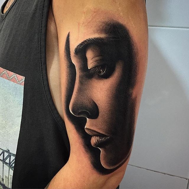 Realism style colored shoulder tattoo of woman portrait