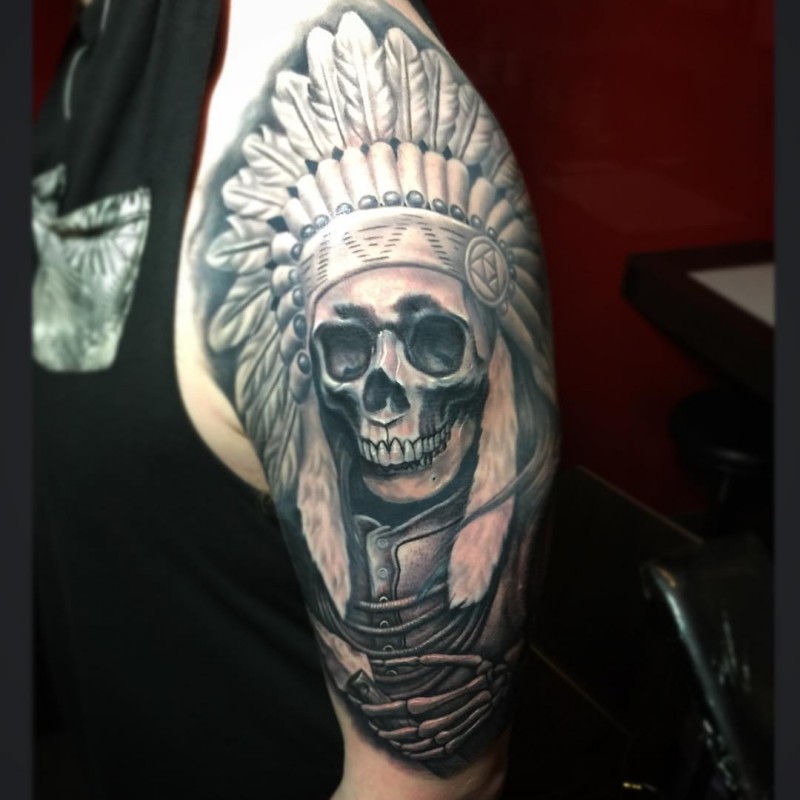 Realism style colored shoulder tattoo of Indian skeleton with helmet