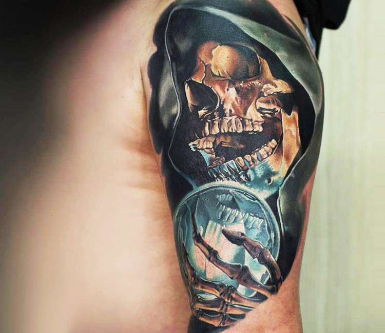 Realism style colored shoulder tattoo of skeleton in hood with magic orb